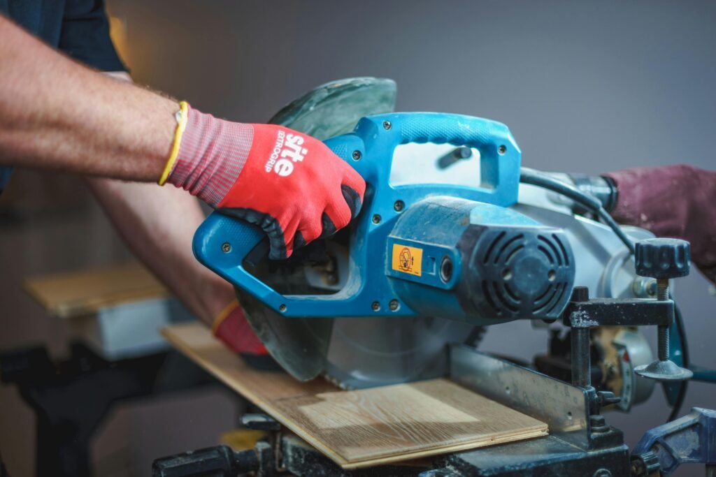 Carpenter using a circular saw to cut wood, showcasing precision craftsmanship.
