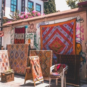 Vibrant Turkish rugs and textiles on display outdoors in Antalya, Türkiye.