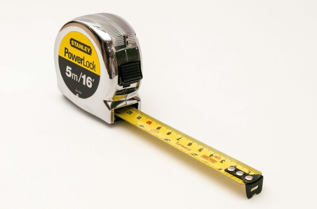A close-up photograph of a Stanley PowerLock 5m/16ft measuring tape on a white background.