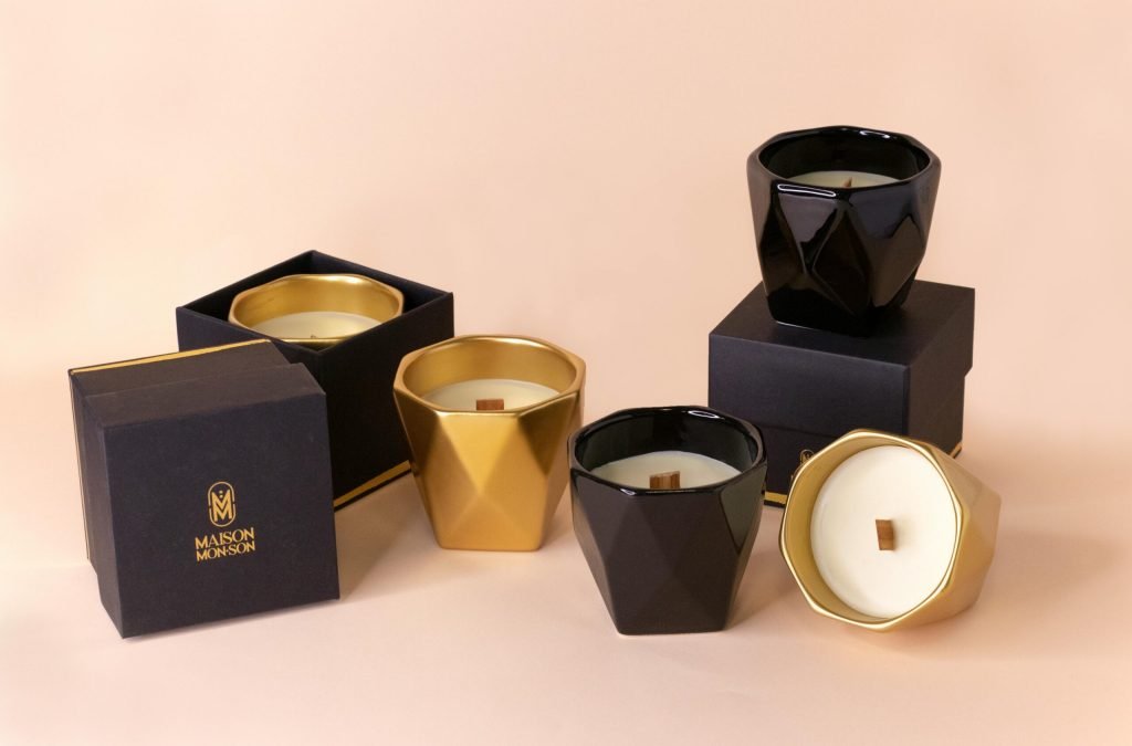 Luxurious black and gold candles in decorative holders, perfect for home decor.